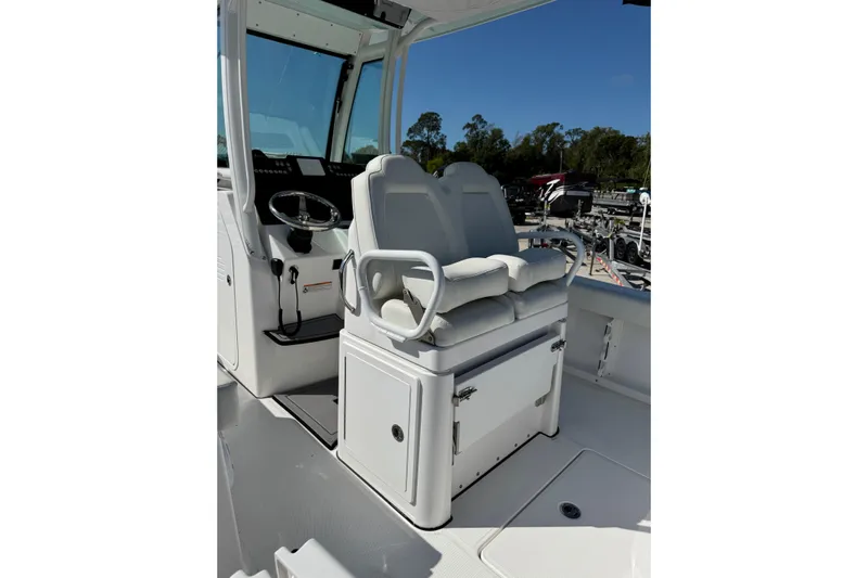  Yacht Photos Pics 2024 Everglades 235 Center Console boat interior with dual seating and steering wheel.