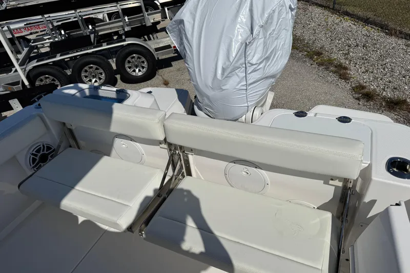  Yacht Photos Pics 2024 Everglades 235 Center Console boat with white seating and covered engine.