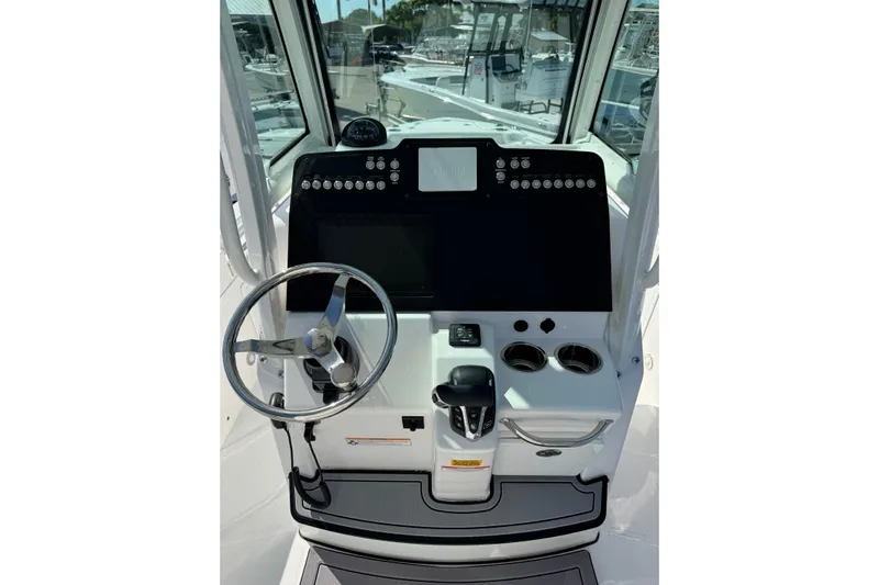  Yacht Photos Pics 2024 Everglades 235 Center Console boat dashboard with steering wheel and controls.