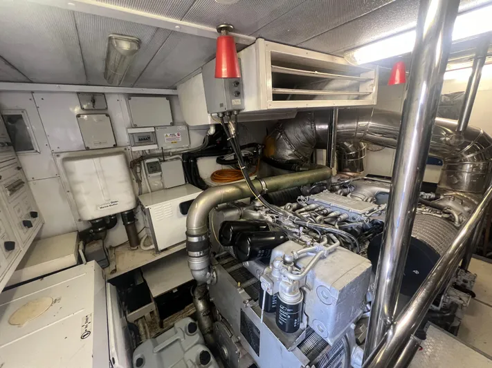 Dubai Yacht Photos Pics Engine room of a 2003 Maiora 24 S yacht, featuring complex machinery and piping.