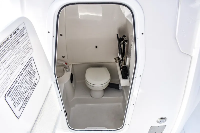 Yacht Photos Pics 2025 Sea Hunt Gamefish 30 boat interior with compact marine toilet.