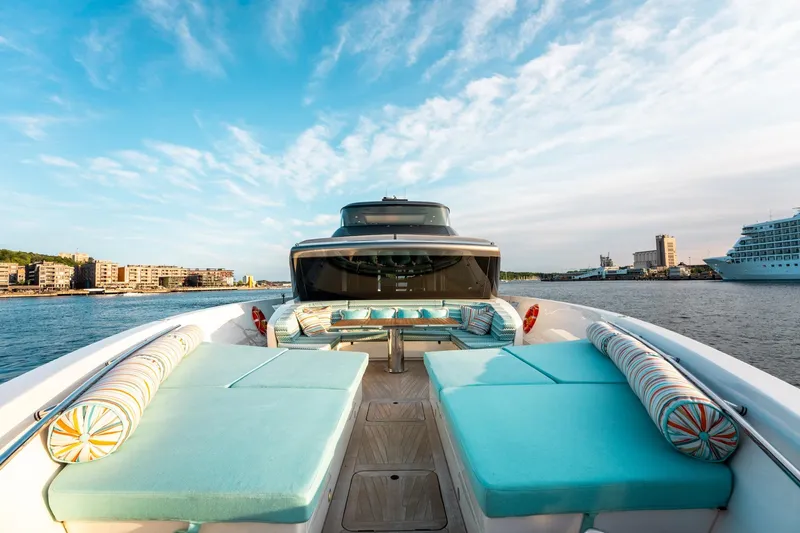 North Yacht Photos Pics Luxurious 2020 Sanlorenzo SX88 yacht with spacious deck and vibrant seating, docked in a scenic harbor.