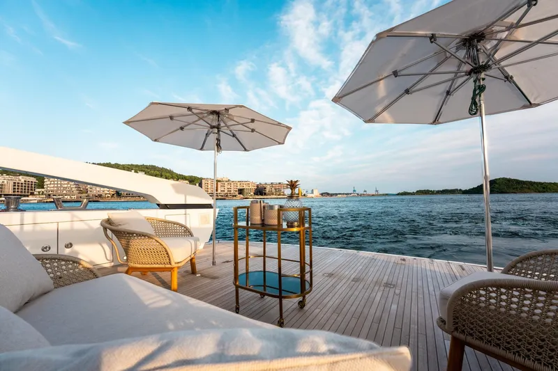 North Yacht Photos Pics Luxurious Sanlorenzo SX88 yacht deck with umbrellas, chairs, and ocean view, 2020 model.