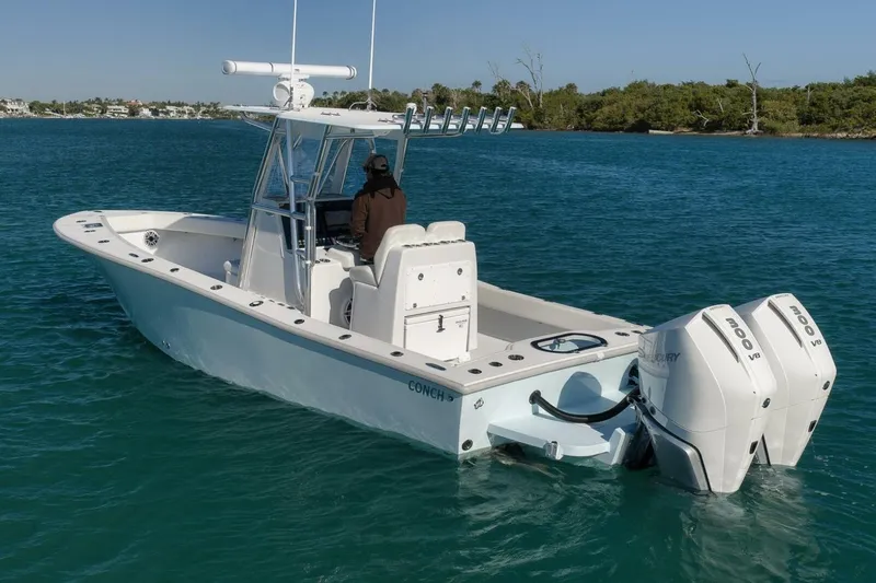  Yacht Photos Pics 2025 Conch 27 boat with dual Mercury engines on calm water.
