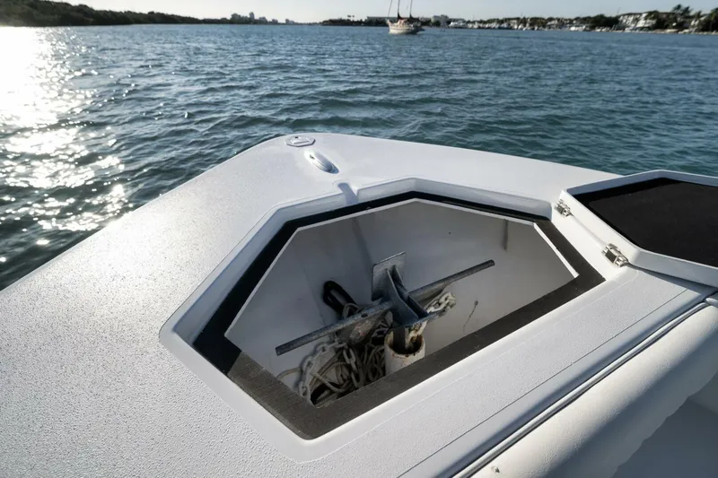  Yacht Photos Pics Bow of 2025 Conch 27 boat with anchor storage, on calm water.
