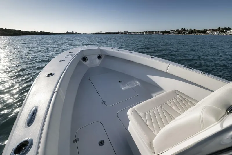  Yacht Photos Pics 2025 Conch 27 boat on calm water, featuring sleek design and comfortable seating.