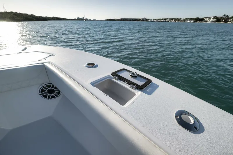  Yacht Photos Pics 2025 Conch 27 boat deck with open hatch, speaker, and scenic water view.