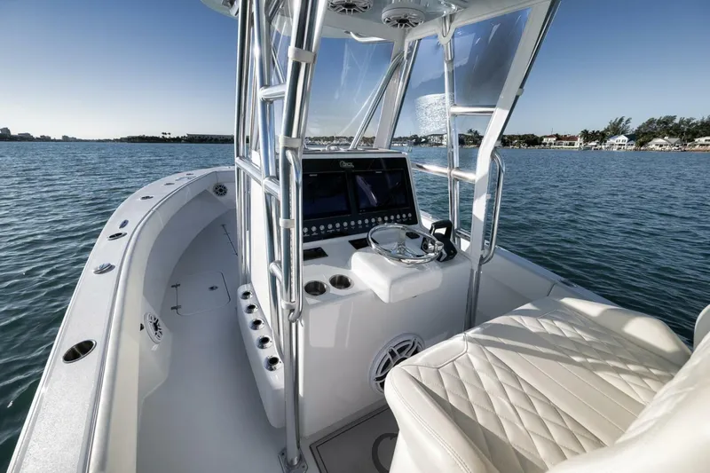  Yacht Photos Pics 2025 Conch 27 boat interior with modern helm and luxurious seating on calm water.