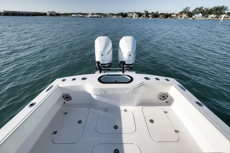  Yacht Photos Pics 2025 Conch 27 boat with dual engines on calm water.