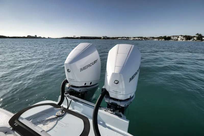  Yacht Photos Pics Twin Mercury outboard engines on a 2025 Conch 27 boat, cruising on calm waters.