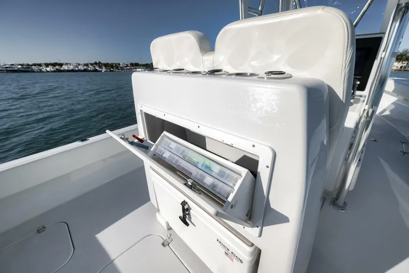  Yacht Photos Pics 2025 Conch 27 boat with open storage compartment on deck, near marina.