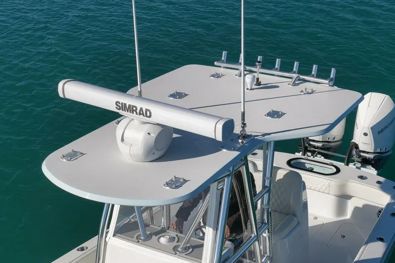  Yacht Photos Pics 2025 Conch 27 boat with Simrad radar, dual Mercury engines, and sleek design on blue water.