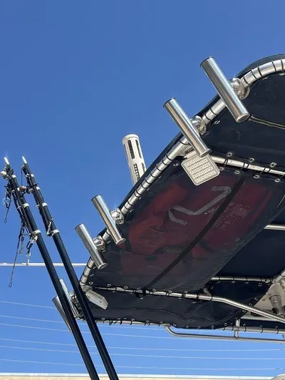  Yacht Photos Pics 2003 Grady-White 306 Bimini boat with fishing rod holders against clear blue sky.