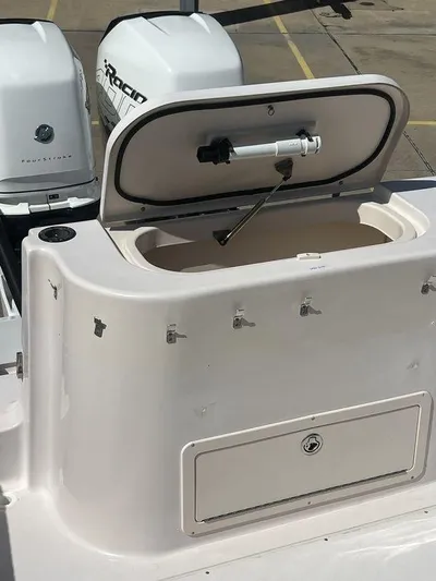  Yacht Photos Pics 2003 Grady-White 306 Bimini boat with open storage compartment and visible outboard engines.