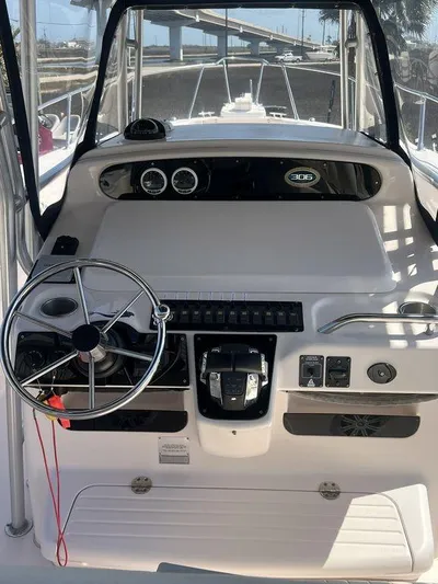 Yacht Photos Pics 2003 Grady-White 306 Bimini boat helm with steering wheel and control panel.