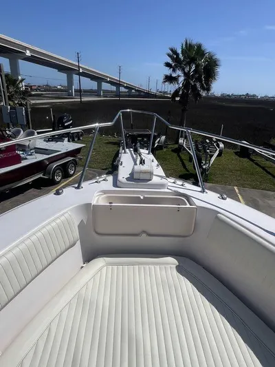  Yacht Photos Pics 2003 Grady-White 306 Bimini boat with white seating, docked near a highway and palm tree.