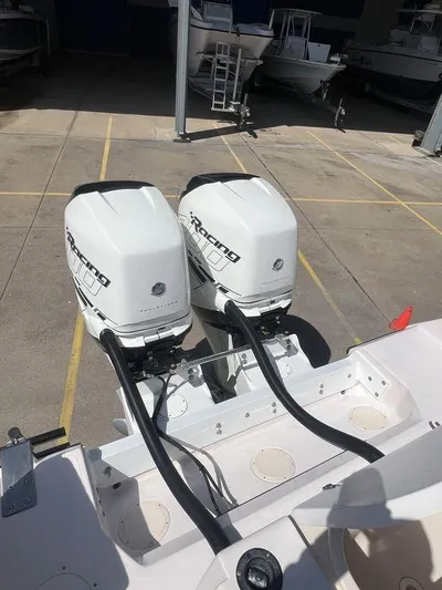  Yacht Photos Pics 2003 Grady-White 306 Bimini boat with twin outboard motors in a marina.