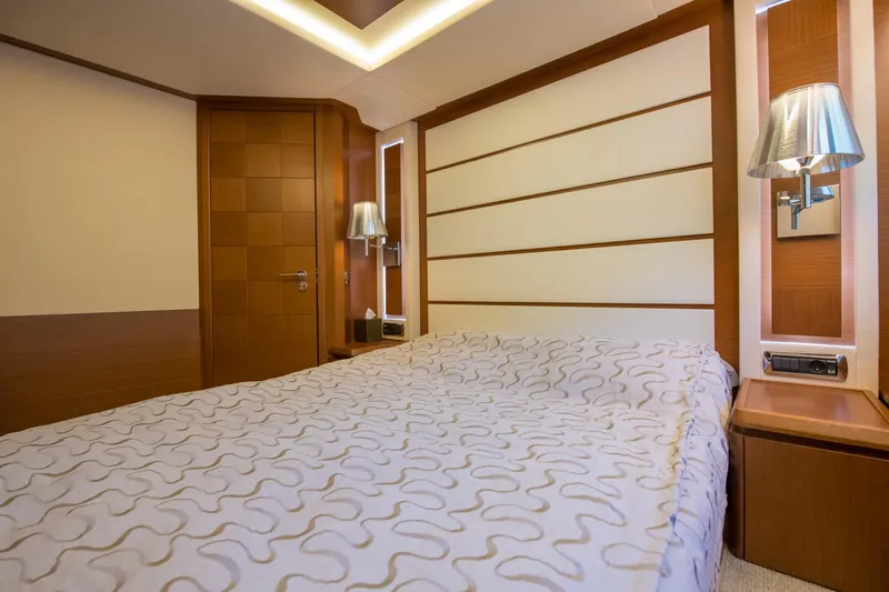 La Rubia Yacht Photos Pics Luxurious bedroom interior on 2011 Azimut La Rubia yacht, featuring elegant wood paneling.