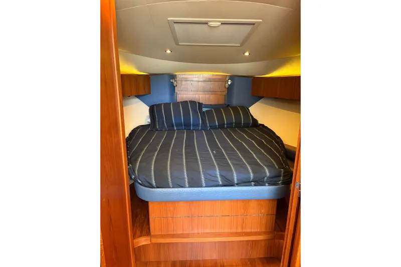 Loophole Yacht Photos Pics 2013 Tiara Yachts 3600 Coronet cabin interior with cozy bed and wooden accents.