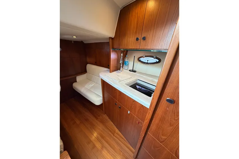 Loophole Yacht Photos Pics Interior of 2013 Tiara Yachts 3600 Coronet with wood cabinetry and white seating.