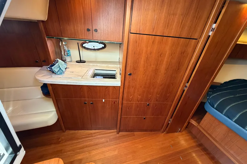 Loophole Yacht Photos Pics Interior of 2013 Tiara Yachts 3600 Coronet with wood cabinetry and seating area.