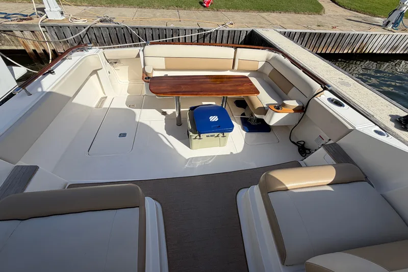 Loophole Yacht Photos Pics 2013 Tiara Yachts 3600 Coronet cockpit with seating, table, and cooler.