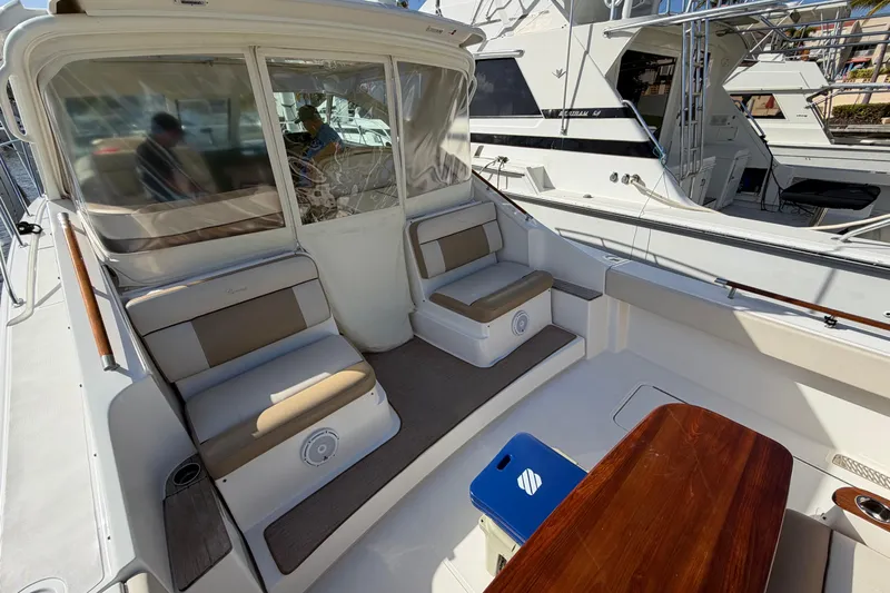 Loophole Yacht Photos Pics 2013 Tiara Yachts 3600 Coronet interior with seating and table, docked at marina.