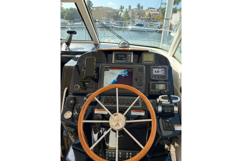 Loophole Yacht Photos Pics Helm of 2013 Tiara Yachts 3600 Coronet with navigation equipment and wooden steering wheel.