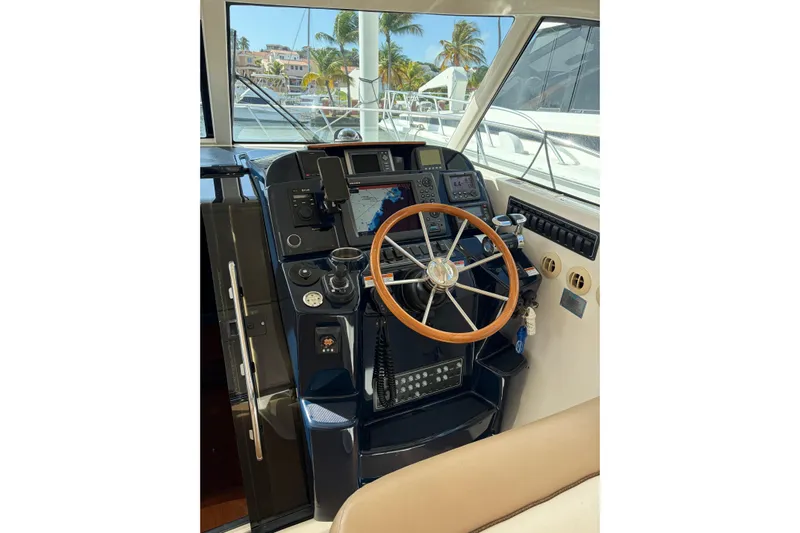 Loophole Yacht Photos Pics Helm of 2013 Tiara Yachts 3600 Coronet with navigation equipment and wooden steering wheel.
