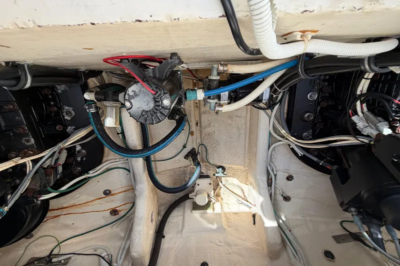 Loophole Yacht Photos Pics Engine compartment of a 2013 Tiara Yachts 3600 Coronet, showcasing wiring and mechanical components.