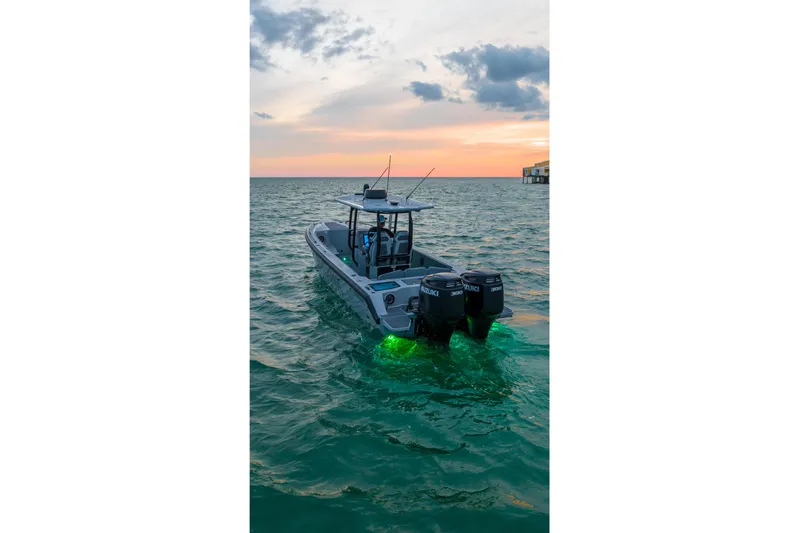  Yacht Photos Pics Dynamic D-305V boat at sunset with glowing underwater lights, 2023 model.