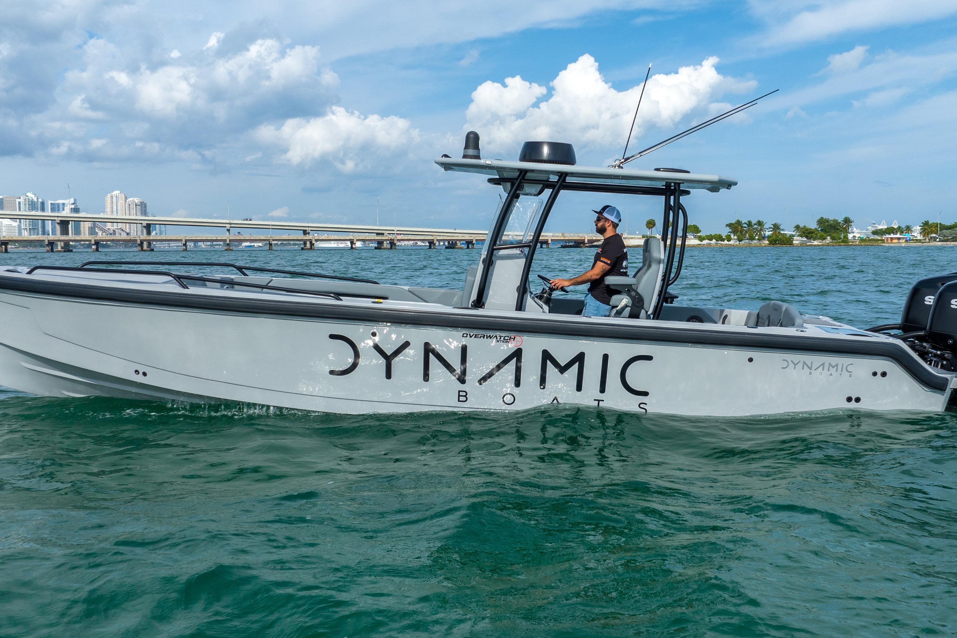 2024 Dynamic D-305V boat cruising on clear waters under a blue sky.