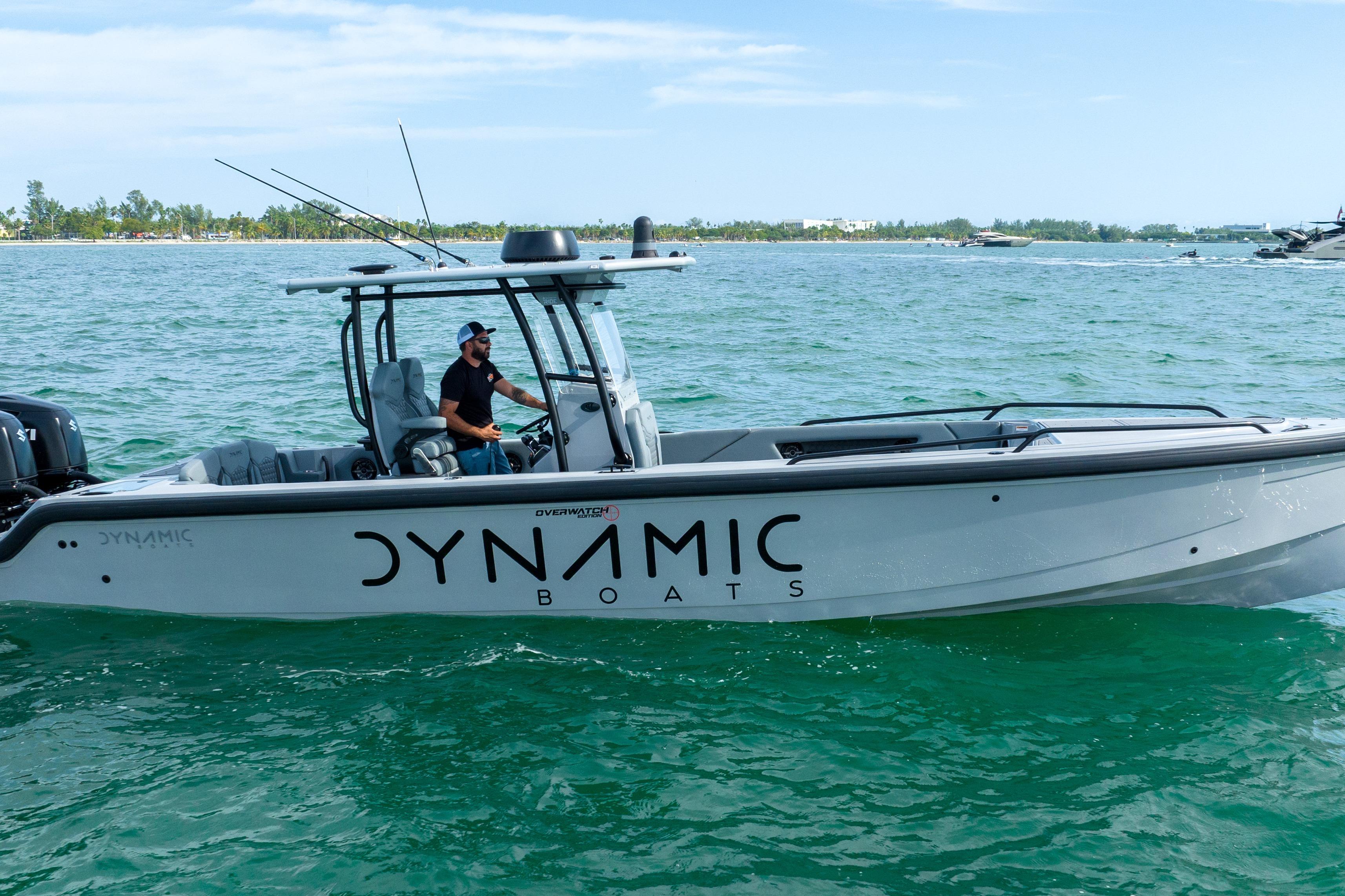 2024 Dynamic D-305V boat cruising on clear blue water.