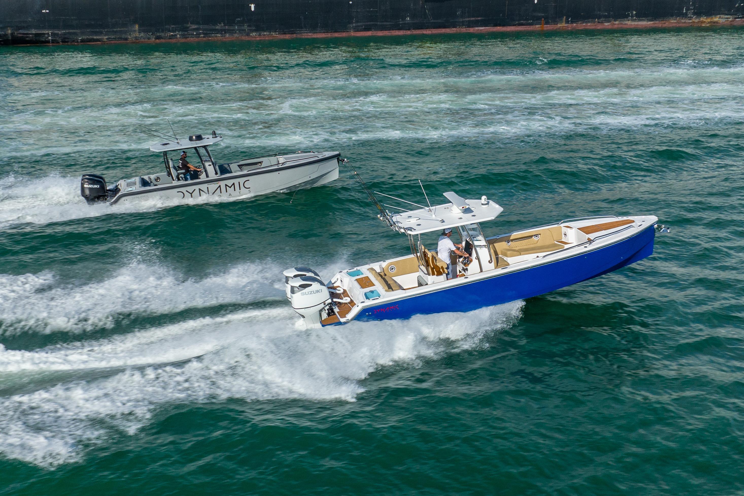 Two Dynamic boats, including a 2024 D-305V, speed through ocean waves.