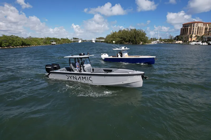  Yacht Photos Pics 2024 Dynamic D-305V boat cruising on a sunny day in a scenic waterway.