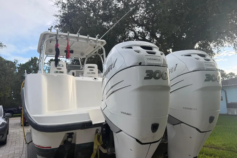 Yacht Photos Pics 2011 Boston Whaler 285 Conquest with dual Mercury 300 Verado engines, parked outdoors.