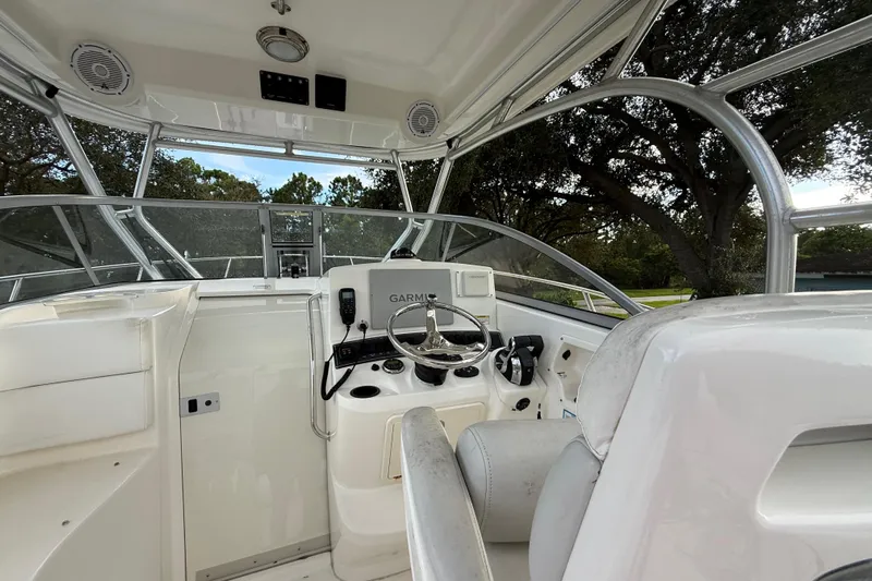  Yacht Photos Pics 2011 Boston Whaler 285 Conquest helm with steering wheel and navigation equipment.