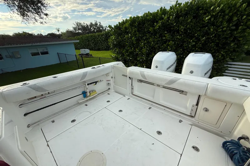  Yacht Photos Pics 2011 Boston Whaler 285 Conquest boat deck with dual Mercury engines, outdoor setting.