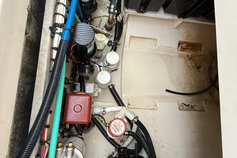  Yacht Photos Pics Engine compartment of a 2011 Boston Whaler 285 Conquest, showcasing various mechanical components.