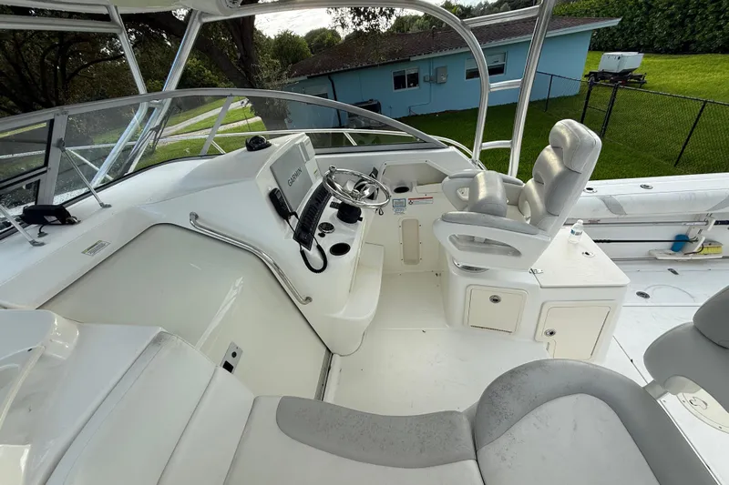  Yacht Photos Pics 2011 Boston Whaler 285 Conquest helm with steering wheel and navigation equipment.
