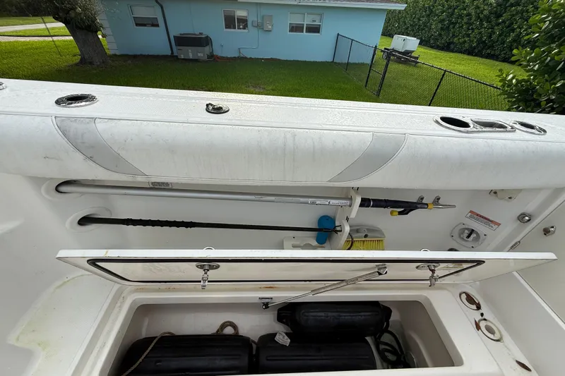  Yacht Photos Pics 2011 Boston Whaler 285 Conquest storage compartment with fishing gear and equipment.