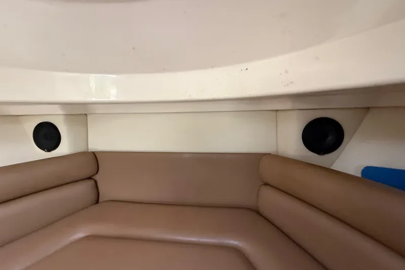  Yacht Photos Pics 2011 Boston Whaler 285 Conquest cabin interior with brown seating and built-in speakers.