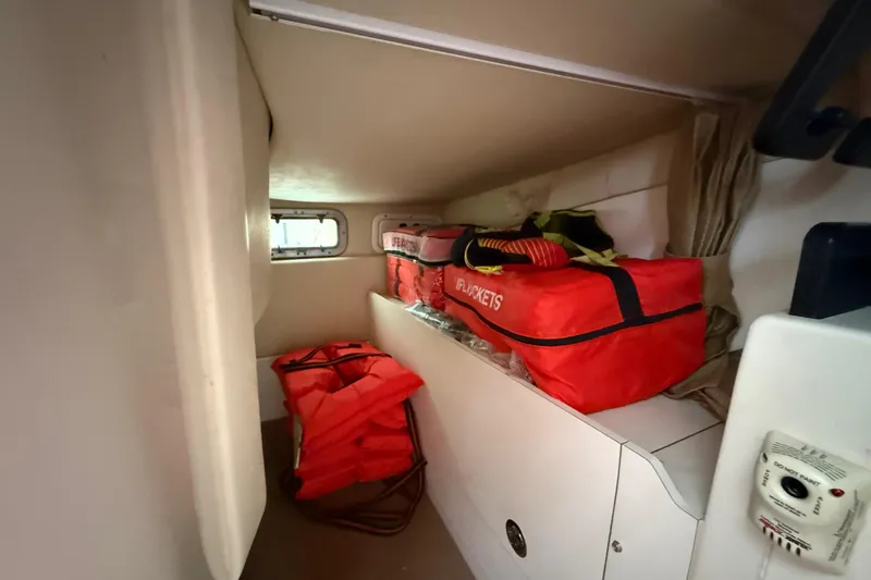  Yacht Photos Pics Interior cabin of 2011 Boston Whaler 285 Conquest with life jackets and storage.