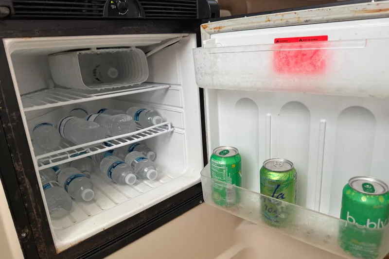  Yacht Photos Pics Mini fridge on 2011 Boston Whaler 285 Conquest with water bottles and soda cans.