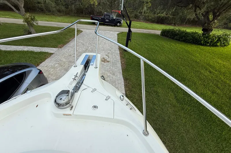  Yacht Photos Pics Bow view of 2011 Boston Whaler 285 Conquest on driveway with cars nearby.