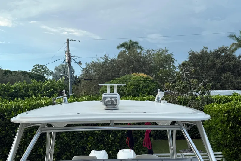  Yacht Photos Pics 2011 Boston Whaler 285 Conquest boat with radar, surrounded by lush greenery.