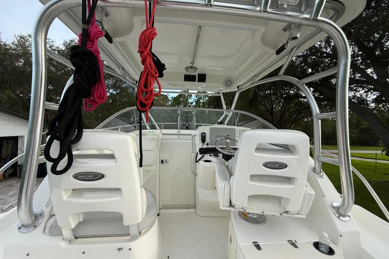  Yacht Photos Pics 2011 Boston Whaler 285 Conquest boat interior with helm and seating area.