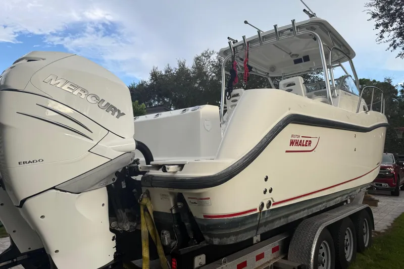  Yacht Photos Pics 2011 Boston Whaler 285 Conquest boat with Mercury engine on trailer.