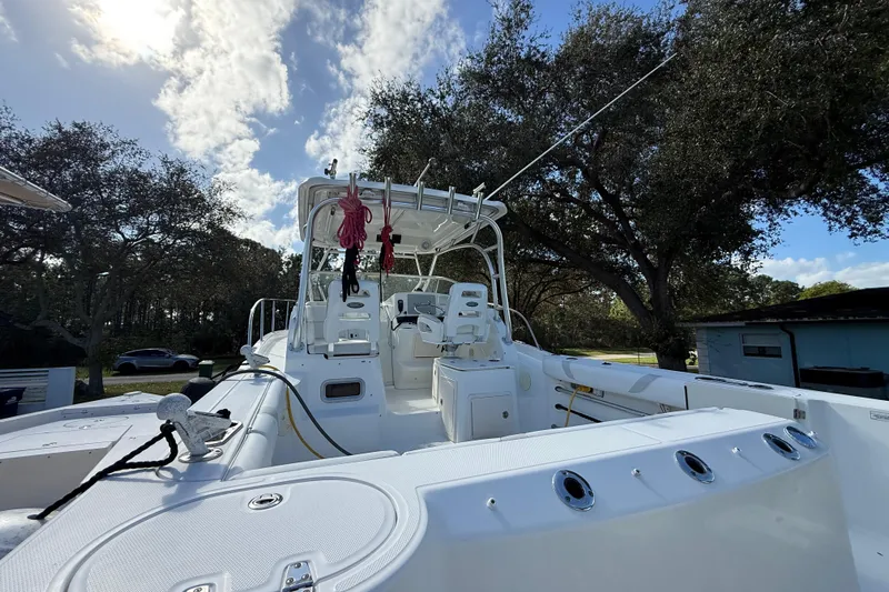  Yacht Photos Pics 2011 Boston Whaler 285 Conquest boat with seating, under a partly cloudy sky.