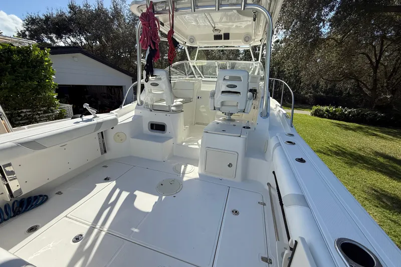  Yacht Photos Pics 2011 Boston Whaler 285 Conquest boat interior with seating and helm, docked outdoors.